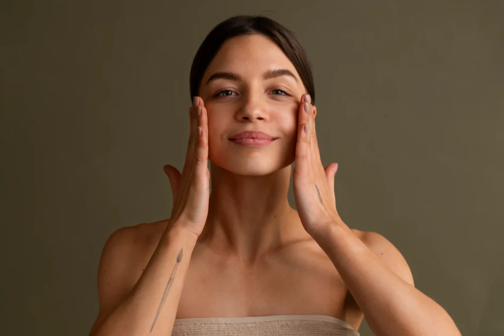 Mujer practicando masaje facial manual como parte de su rutina de autocuidado y bienestar.