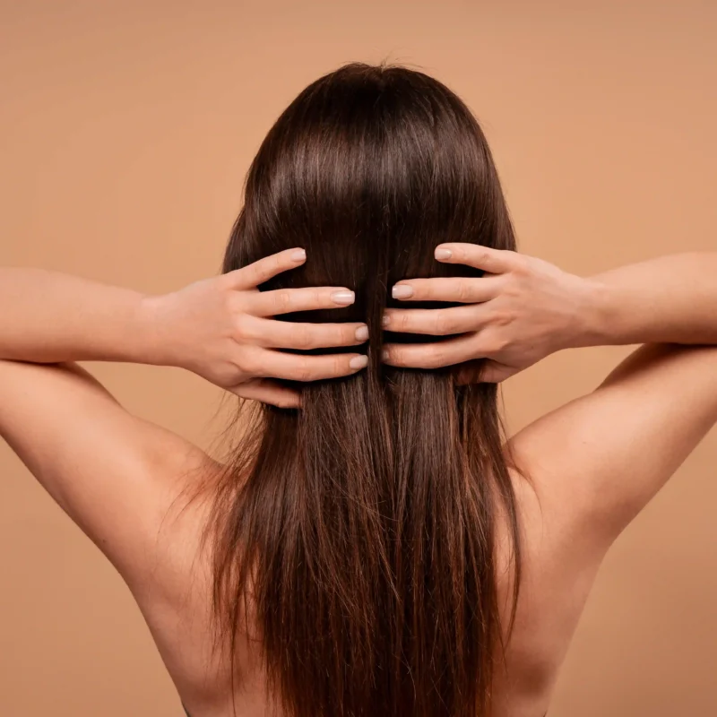 Mujer tocando su cabello sano y brillante