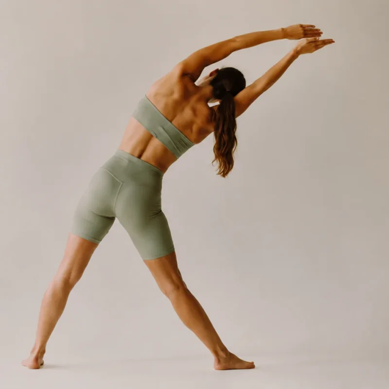 Mujer realizando estiramientos espalda con inclinación lateral y brazos extendidos